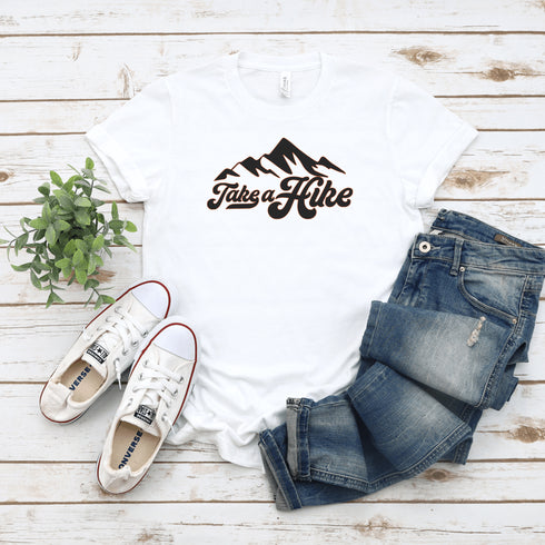 Introducing our rugged and stylish hiking t-shirt, perfect for outdoor enthusiasts and nature lovers alike. Featuring a striking mountain graphic and the motivational slogan "Take A Hike", this shirt is designed to inspire your next camping adventure.